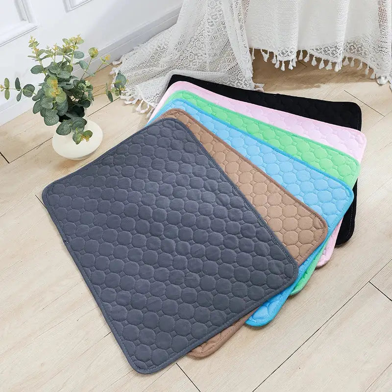 Quilted bath mats in various pastel colors.