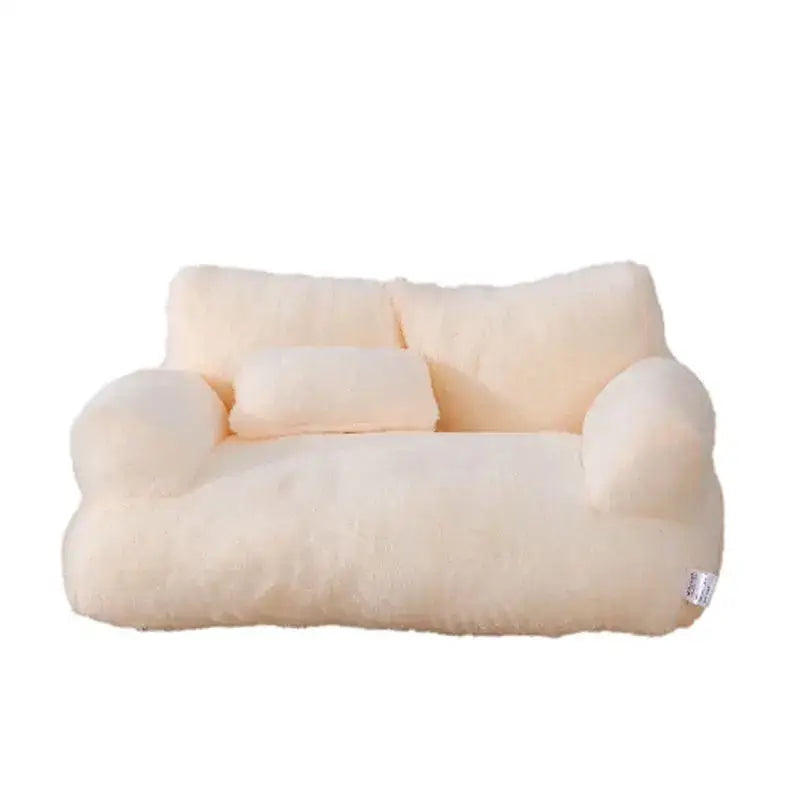 Plush, cream-colored miniature sofa with rounded arms and a cushion.