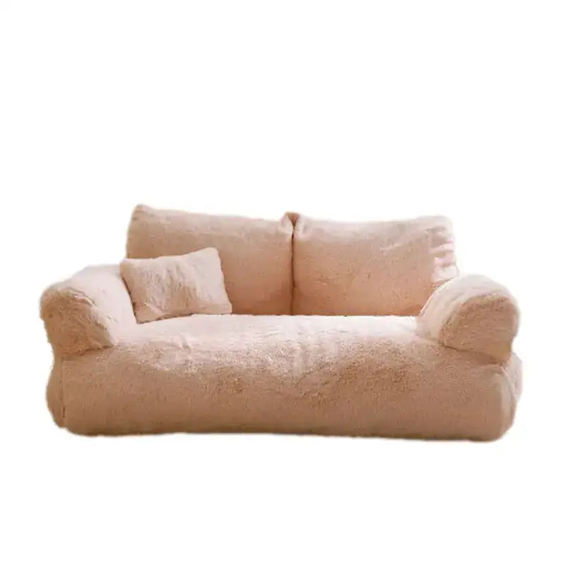 Plush, light pink sofa with rounded edges and a soft, fluffy texture.