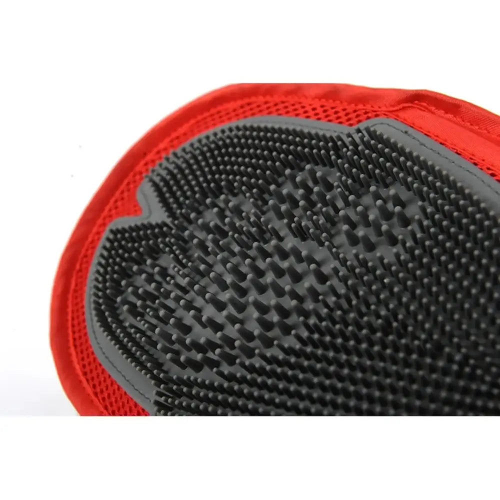 Grooming glove with rubber bristles and red fabric trim.