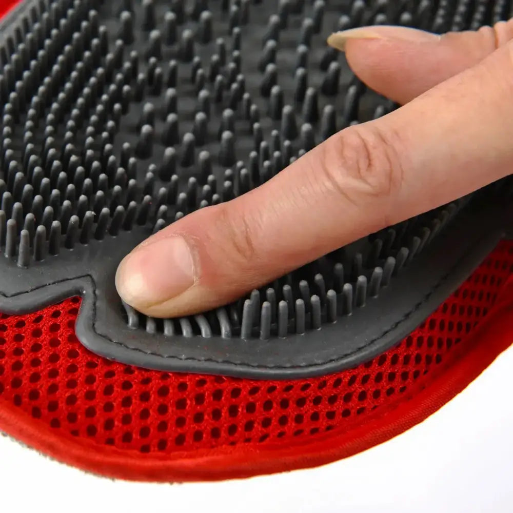 Pet grooming glove with rubber bristles and a red mesh backing.