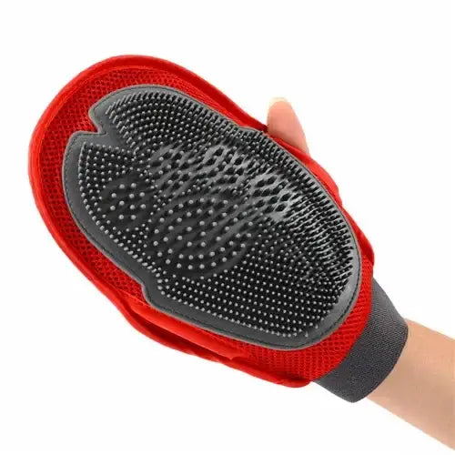 Pet grooming glove with rubber bristles and a red fabric backing.