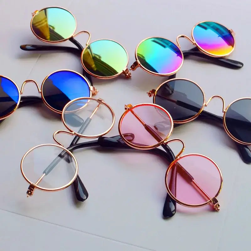 Collection of round sunglasses with colorful lenses and metallic frames.