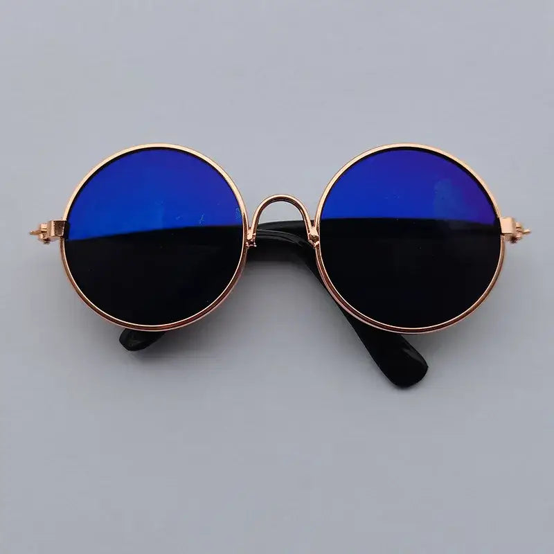 Round sunglasses with gold frames and blue-tinted lenses.