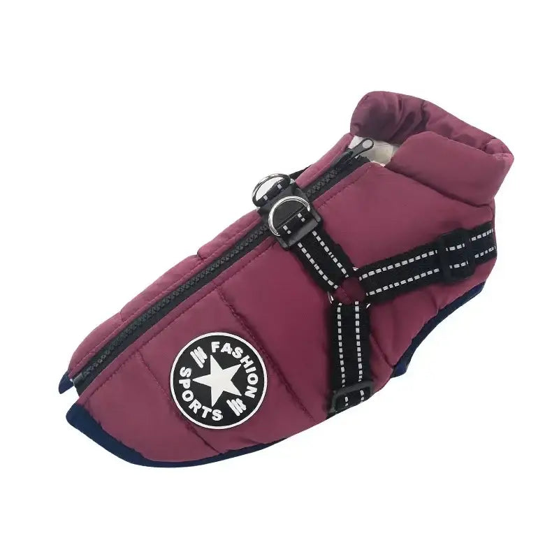 Maroon dog coat with black straps and a circular logo patch.