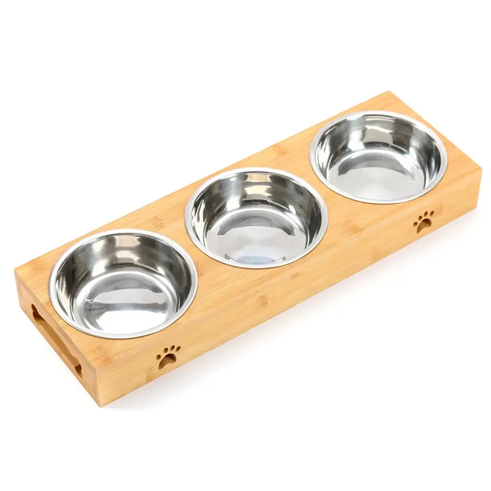 Wooden pet feeding station with three stainless steel bowls and paw print decorations.