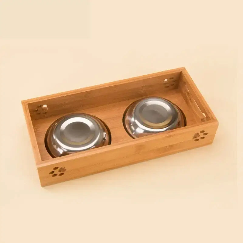 Wooden tray with two metal pet food bowls.