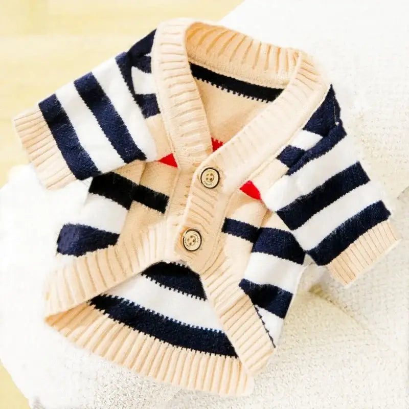 Striped navy and white cardigan sweater with buttons.