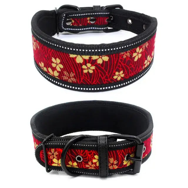 Decorative dog collar with red fabric featuring floral embroidery and black leather trim.