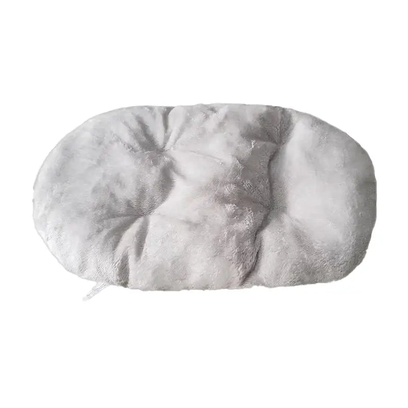 Oval-shaped, plush pet bed or cushion with a tufted surface.