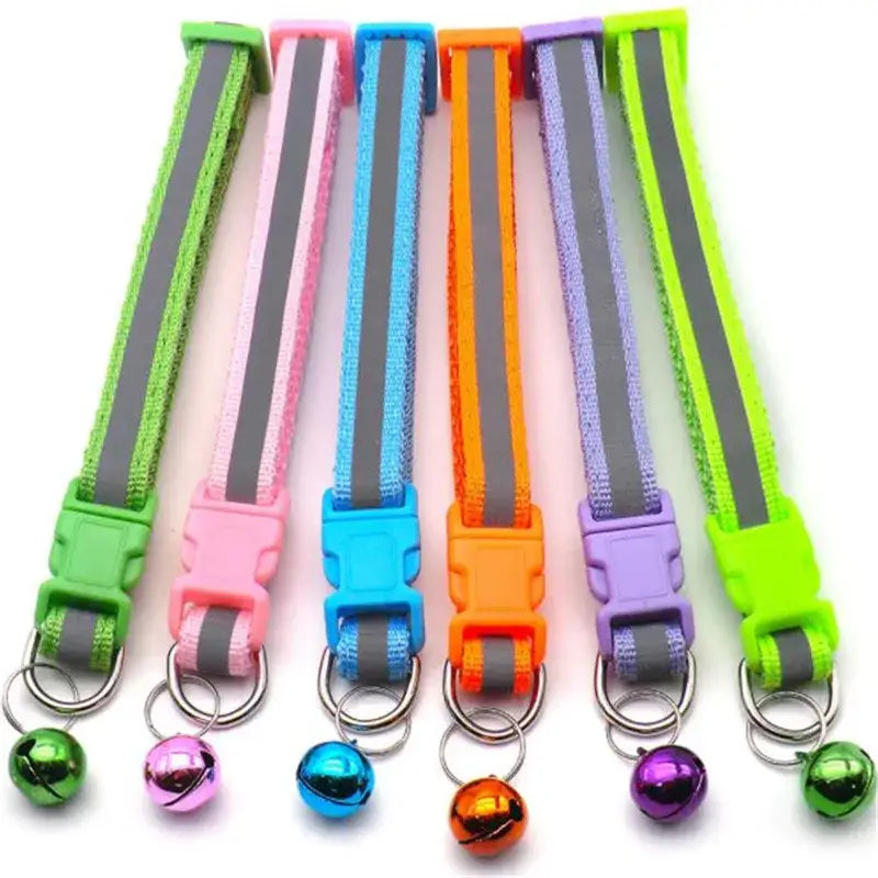 Colorful pet collars with reflective strips and small bells attached.