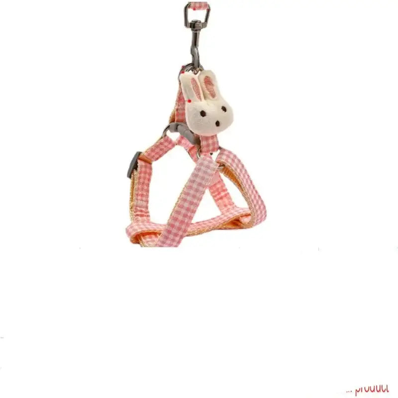 Pink and white gingham dog harness with a small rabbit-shaped attachment.