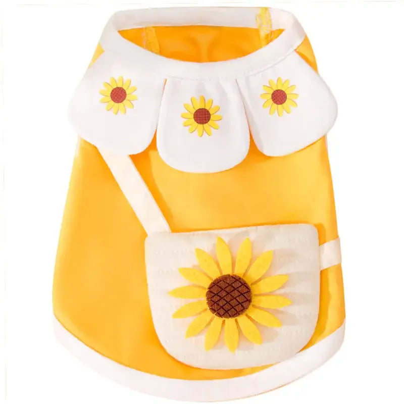 Bright yellow dog vest with white trim and sunflower decorations.