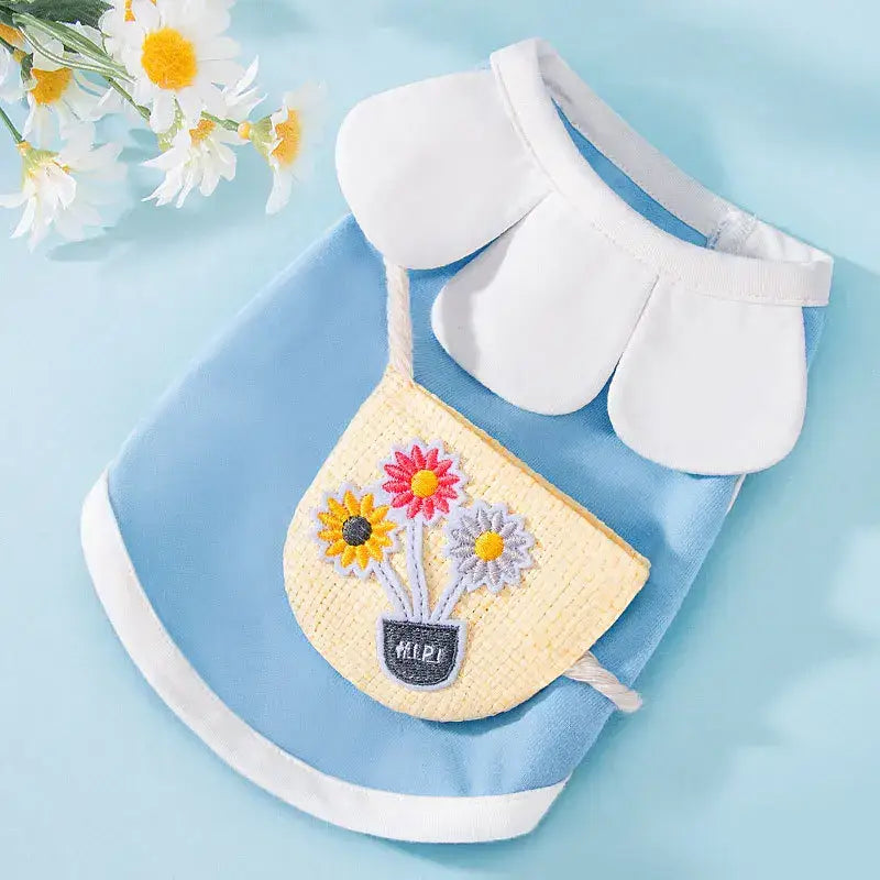 Light blue pet outfit with a white collar and a yellow floral-embroidered pocket.