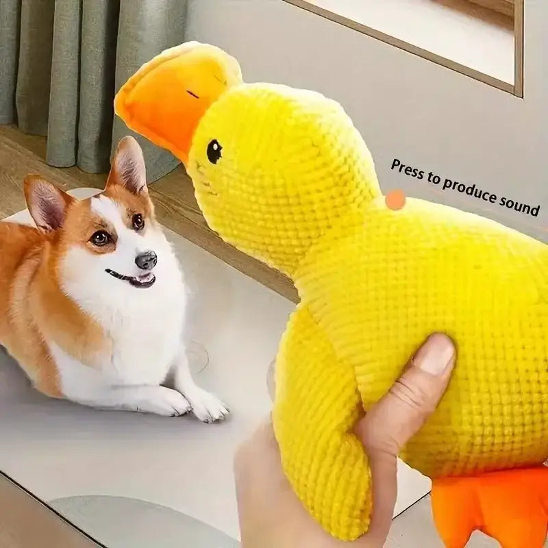 Yellow plush duck toy with orange beak and feet.