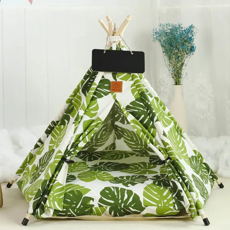 Teepee-style pet tent with a tropical leaf pattern.