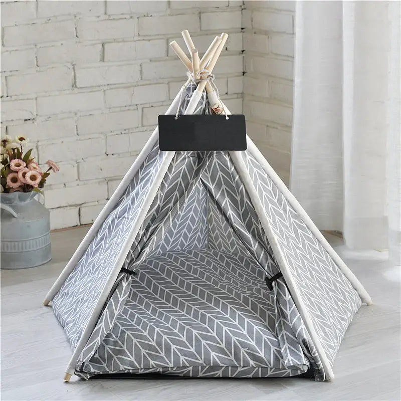 Teepee-style pet tent with gray and white arrow pattern fabric.